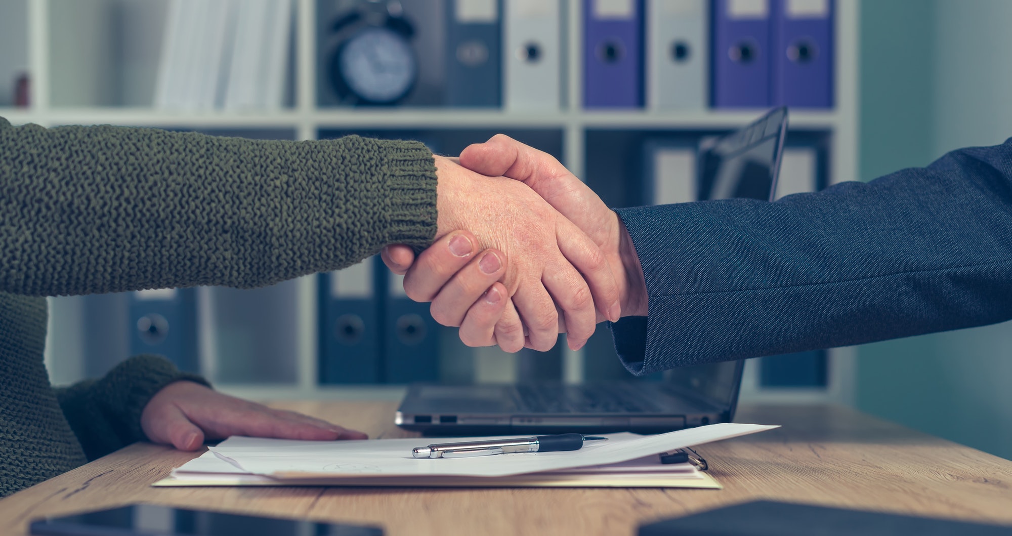 Man and woman shaking hands over business agreement